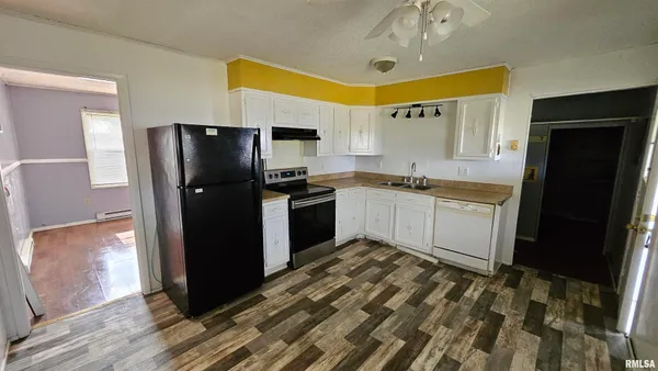 a kitchen with stainless steel appliances granite countertop a refrigerator a sink and dishwasher