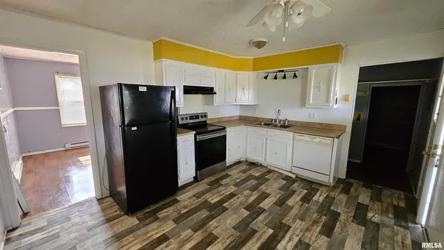 a kitchen with stainless steel appliances granite countertop a refrigerator a sink and dishwasher