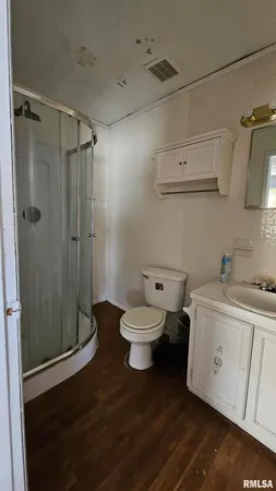 a bathroom with a toilet sink and shower