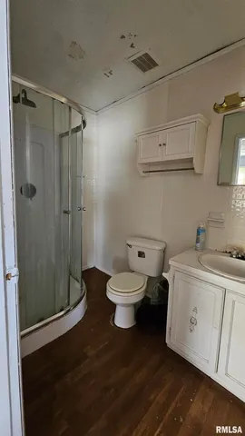 a bathroom with a toilet sink and shower