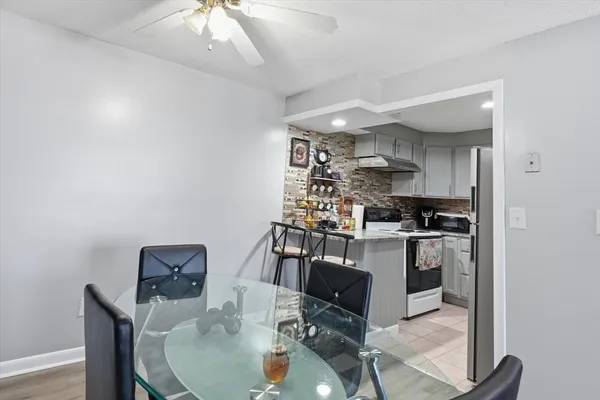 a kitchen with granite countertop a sink cabinets and stainless steel appliances
