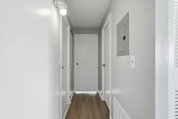 a view of a hallway with wooden floor