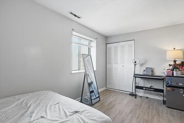 a view of a livingroom with wooden floor and a window