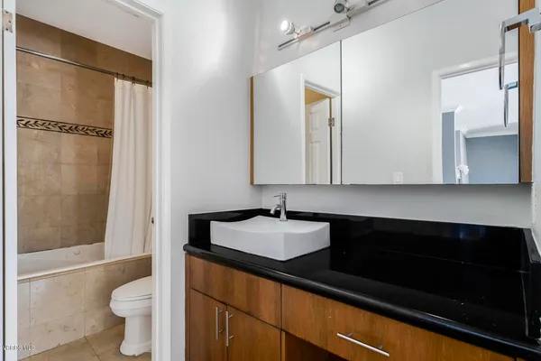 a bathroom with a sink a mirror and a toilet