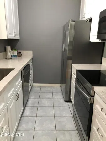 a kitchen with a table and chairs in it