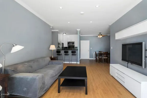 a living room with furniture a wooden floor and a fireplace
