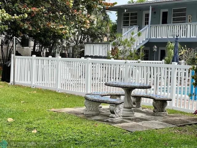 a view of a porch with furniture and floor to ceiling window