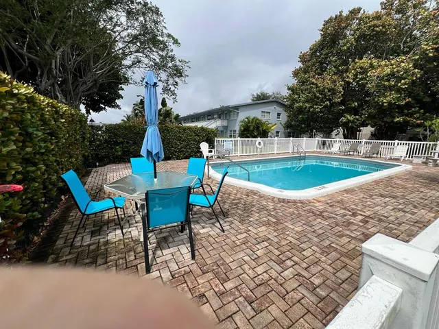 a view of a backyard with sitting area