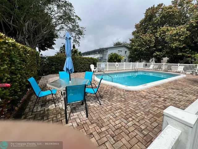 a view of a backyard with sitting area
