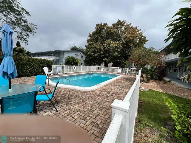 a view of a swimming pool with a patio