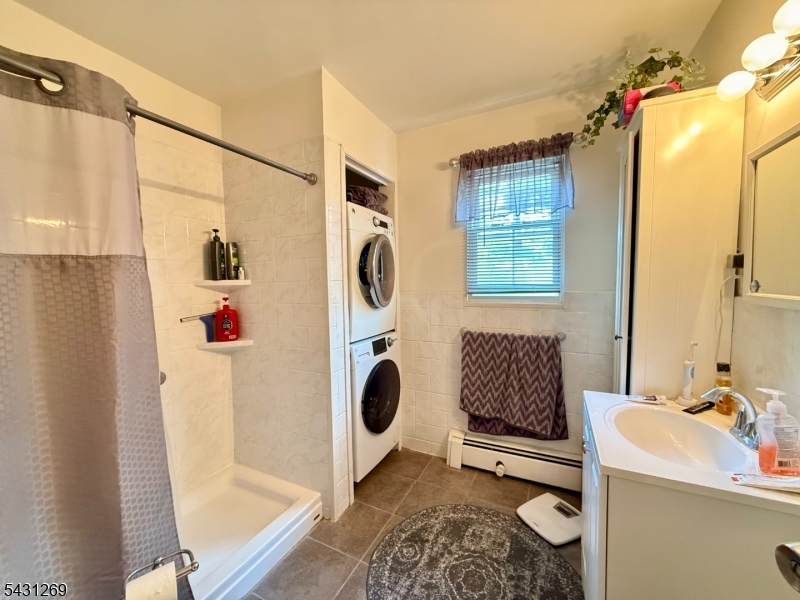 1241 Valley Road, Unit 1241 Wayne, NJ 07470 - Photo 7 of 12 a bathroom with a sink toilet and shower