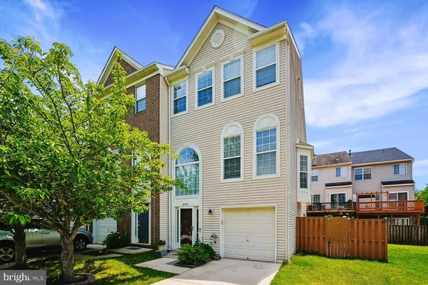 a front view of a residential apartment building with a yard