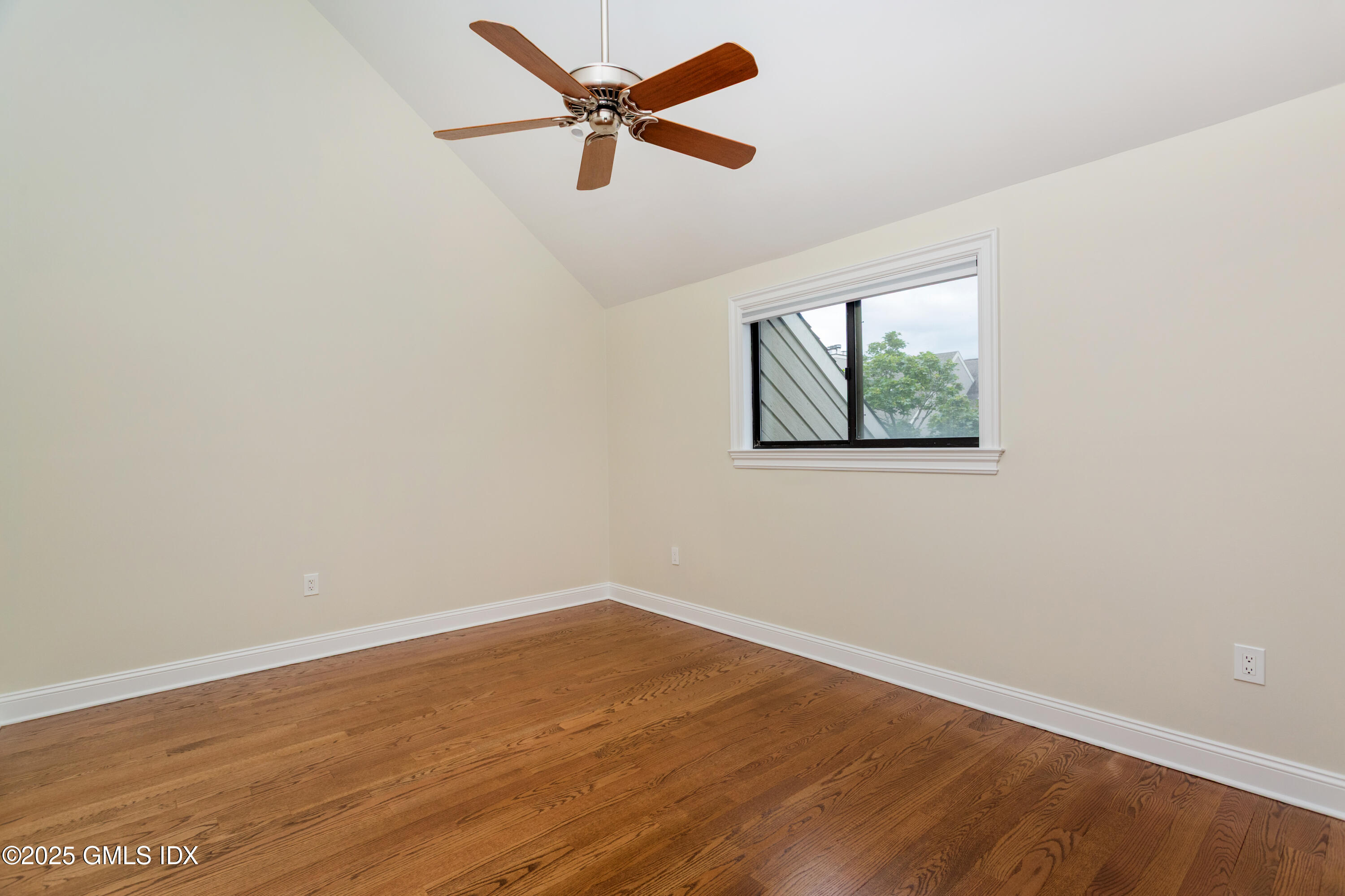 15 River Road, Unit 220 Cos Cob, CT 06807 - Photo 17 of 27 an empty room with wooden floor fan and windows