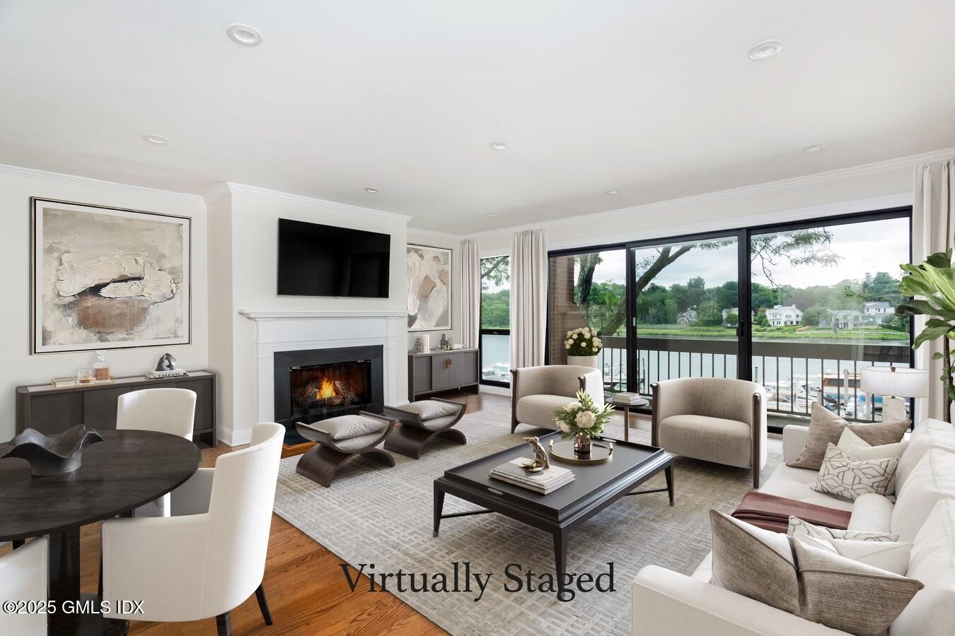15 River Road, Unit 220 Cos Cob, CT 06807 - Photo 4 of 27 a living room with furniture a fireplace and a floor to ceiling window