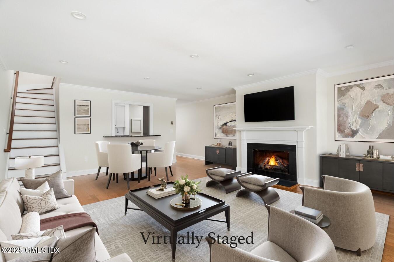 15 River Road, Unit 220 Cos Cob, CT 06807 - Photo 6 of 27 a living room with furniture a fireplace and a flat screen tv