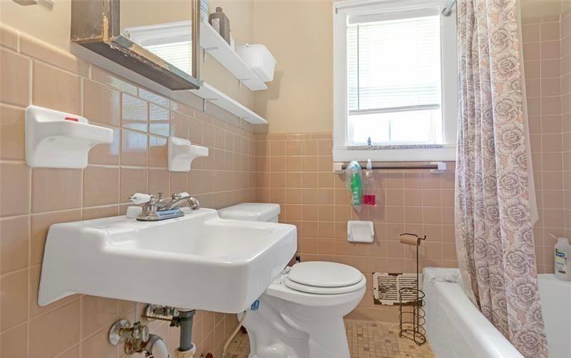 306 Laney Road McDonough, GA 30252 - Photo 15 of 15 a bathroom with a sink a toilet and shower curtain