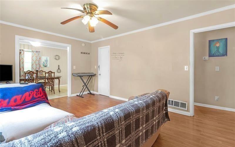 306 Laney Road McDonough, GA 30252 - Photo 3 of 15 a living room with furniture and a dining table with wooden floor