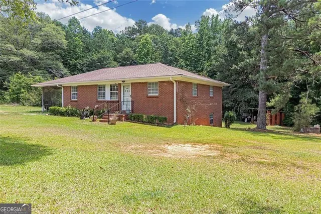 a front view of house with yard and green space