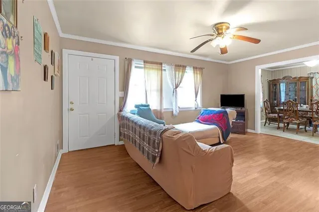 a living room with furniture and chandelier