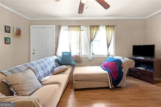 a bedroom with furniture and a flat screen tv