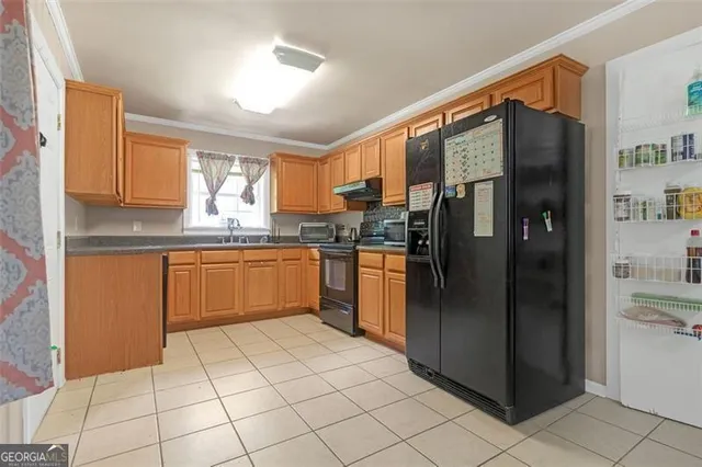 a kitchen with stainless steel appliances granite countertop a refrigerator and a sink