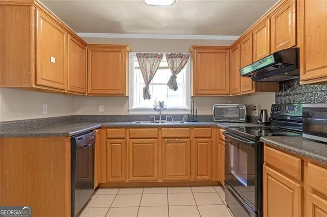 a kitchen with stainless steel appliances granite countertop a sink stove and microwave