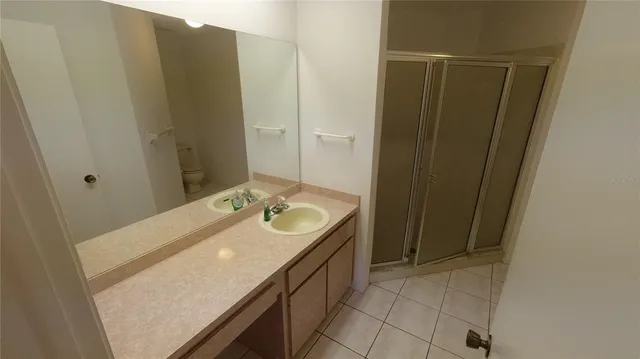 a bathroom with a sink toilet and mirror