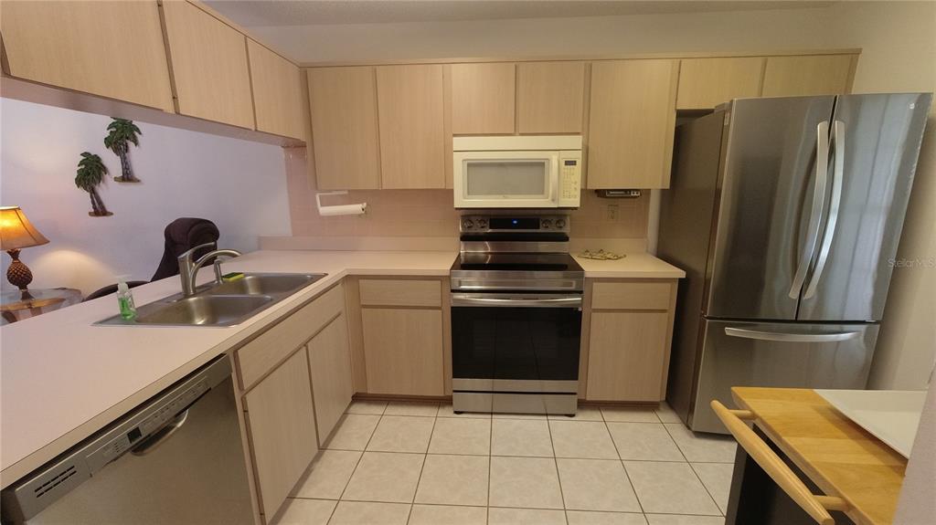 6421 Remus Drive New Port Richey, FL 34653 - Photo 4 of 25 a kitchen with a refrigerator sink and stove