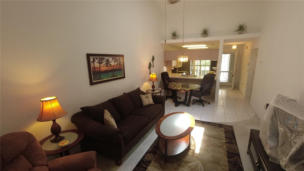 6421 Remus Drive New Port Richey, FL 34653 - Photo 6 of 25 a living room with furniture and a chandelier