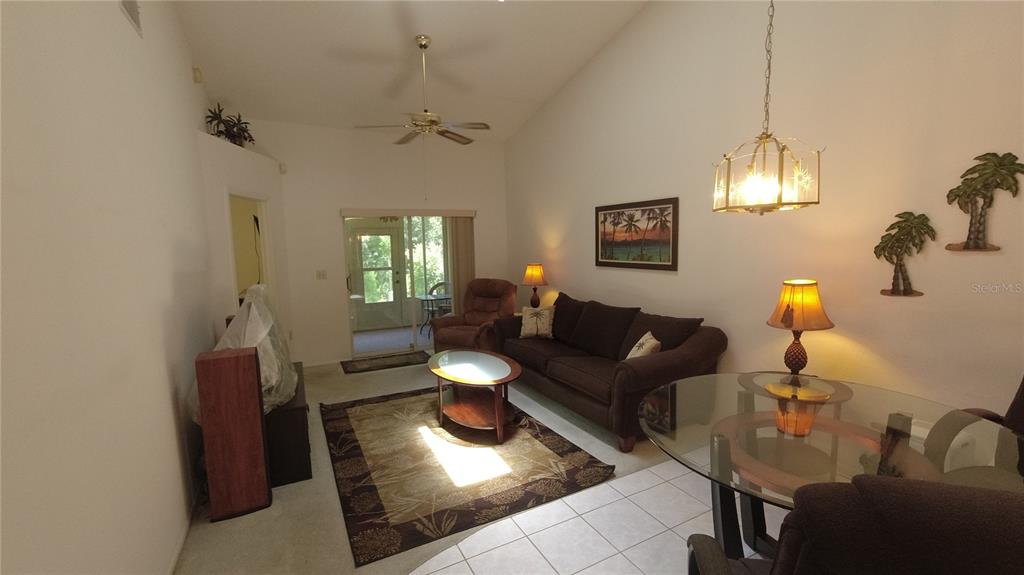 6421 Remus Drive New Port Richey, FL 34653 - Photo 7 of 25 a living room with furniture and a chandelier