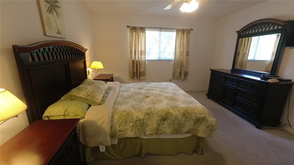 6421 Remus Drive New Port Richey, FL 34653 - Photo 9 of 25 a bed sitting in a bedroom next to a window