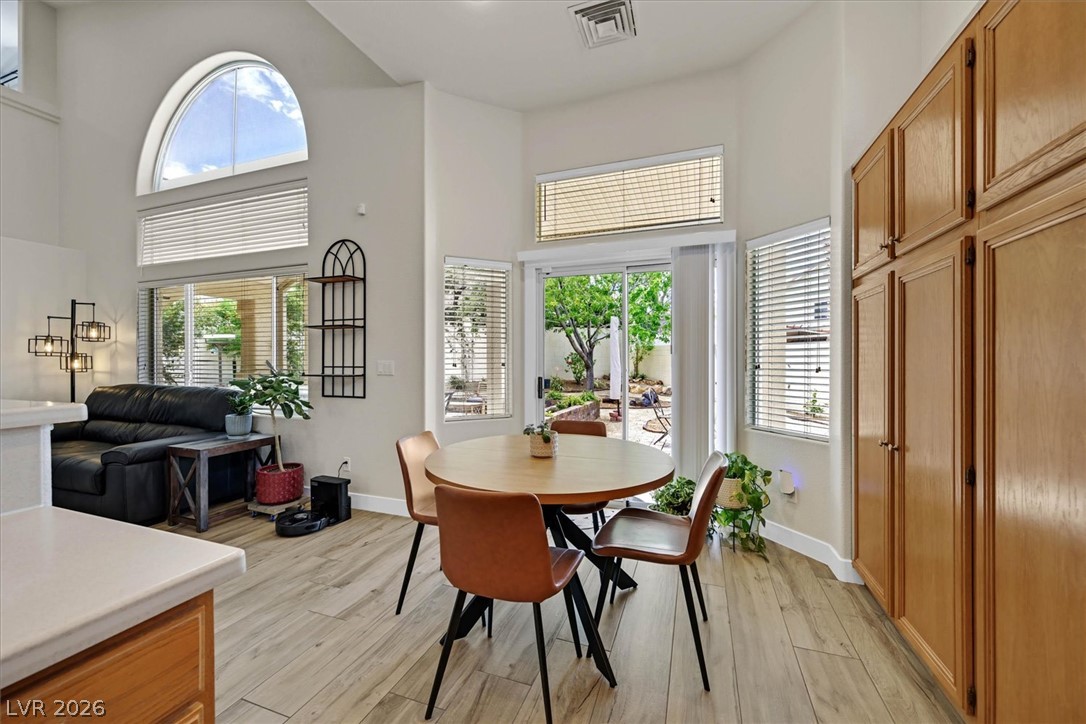 1259 Moon Vision Street Henderson, NV 89052 - Photo 11 of 53 A welcoming dining area with patio access, seamlessly connecting indoor comfort with outdoor tranquility.