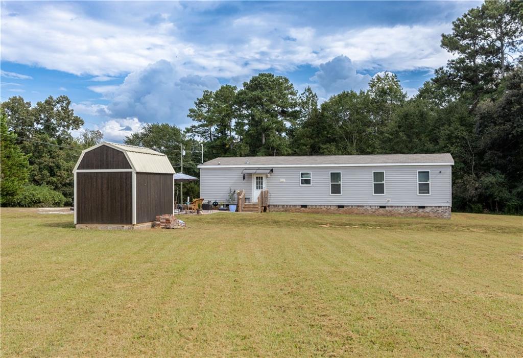 127 Georgia Drive Hartwell, GA 30643 - Photo 21 of 21 a front view of house with yard and trees in the background