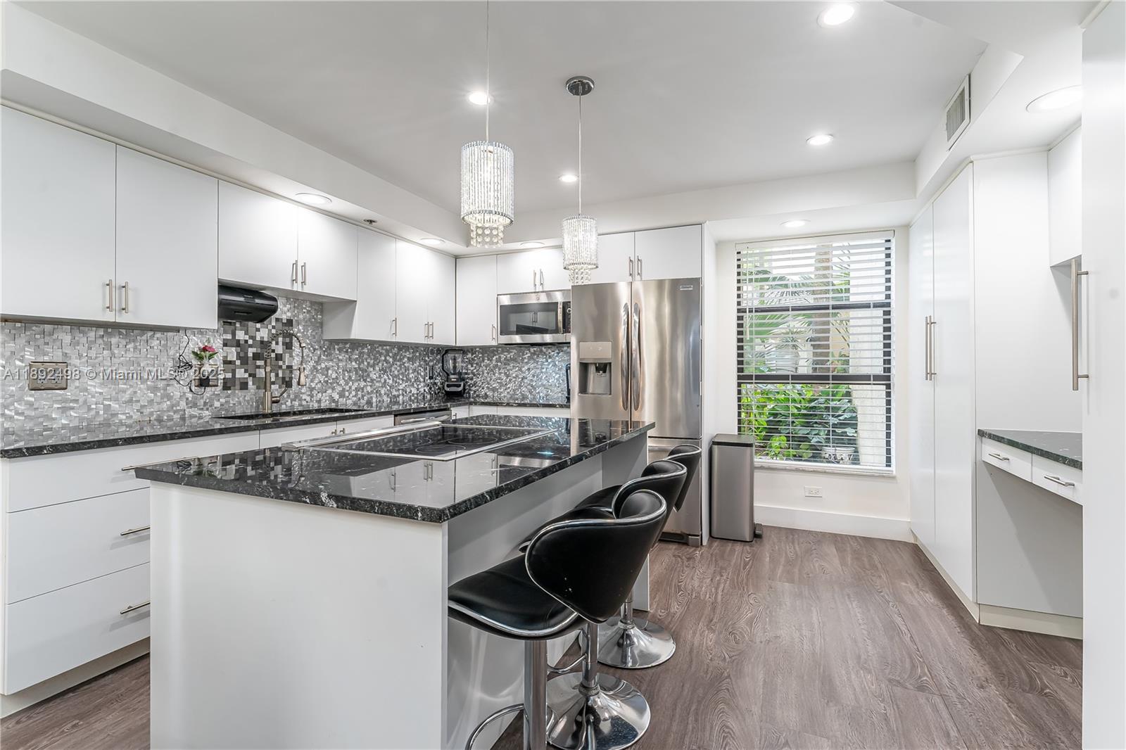 a kitchen with a stove a sink a refrigerator and wooden cabinets