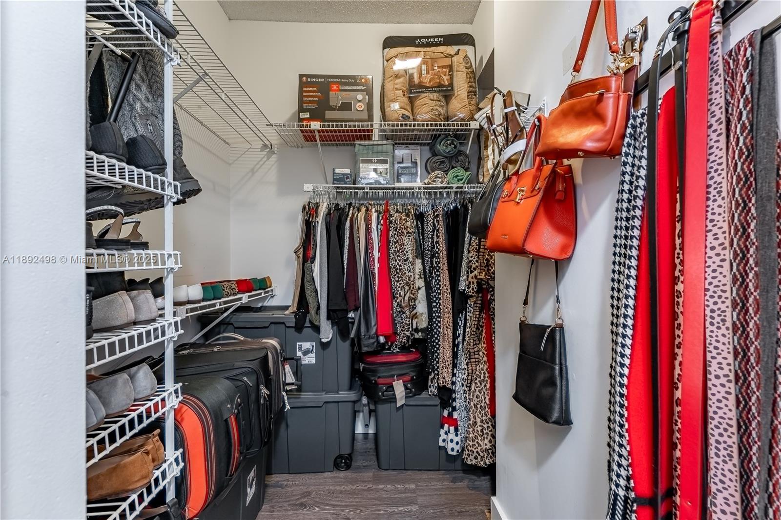 7300 Radice Court, Unit 109 Lauderhill, FL 33319 - Photo 14 of 35 a view of walk in closet with clothes and shoes