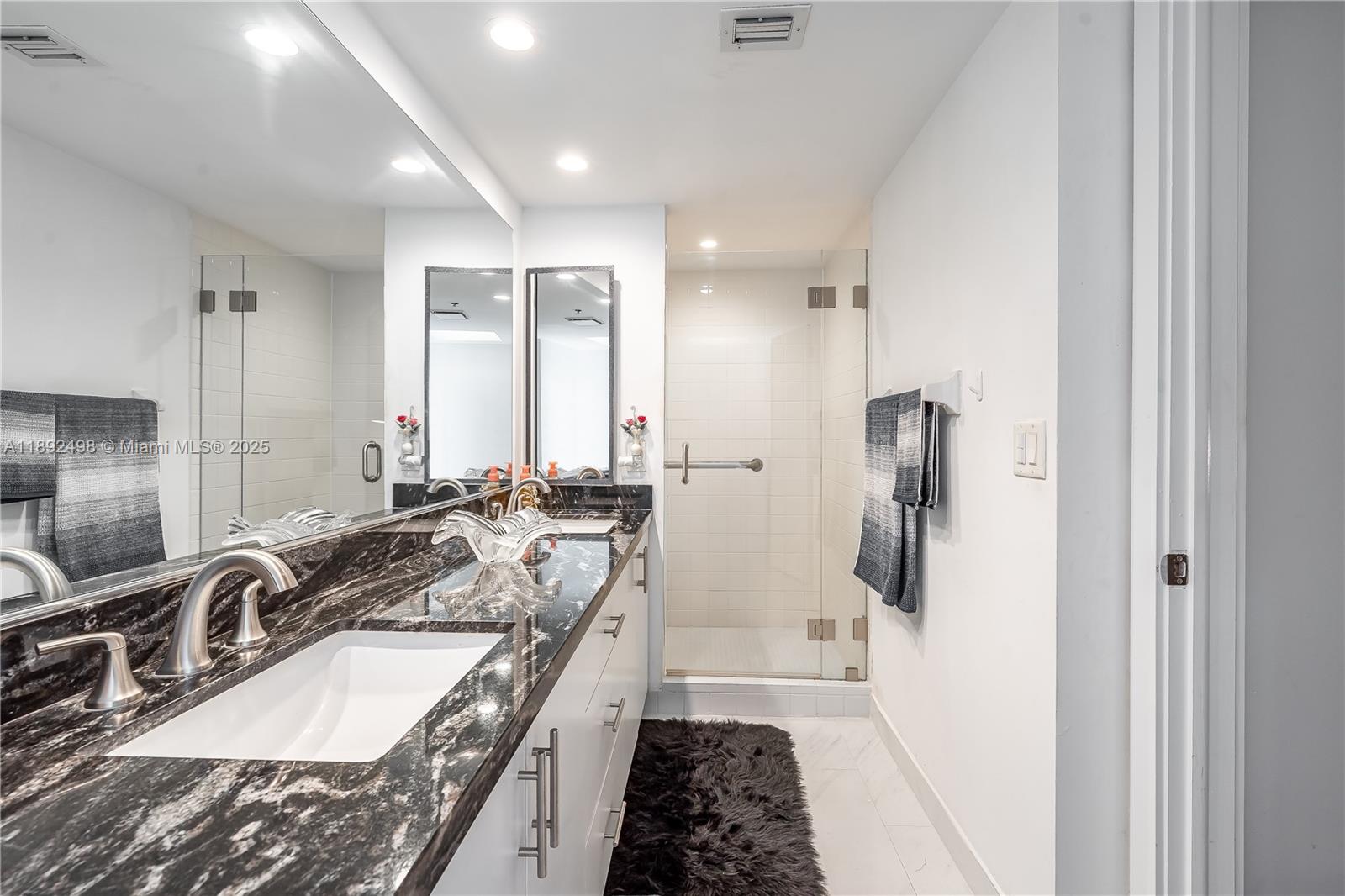 7300 Radice Court, Unit 109 Lauderhill, FL 33319 - Photo 16 of 35 a bathroom with a tub sink and mirror
