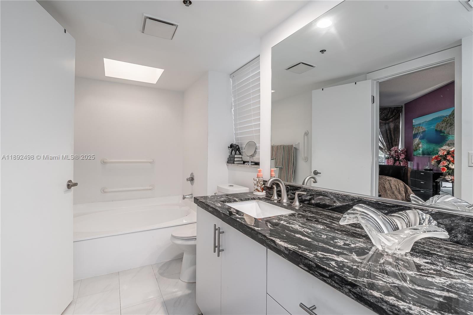 7300 Radice Court, Unit 109 Lauderhill, FL 33319 - Photo 17 of 35 a bath room with a toilet sink and a mirror