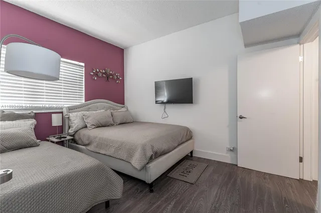 a living room with two couches and a flat screen tv
