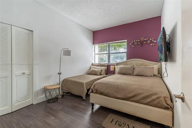 a bed room with two bed and a large window