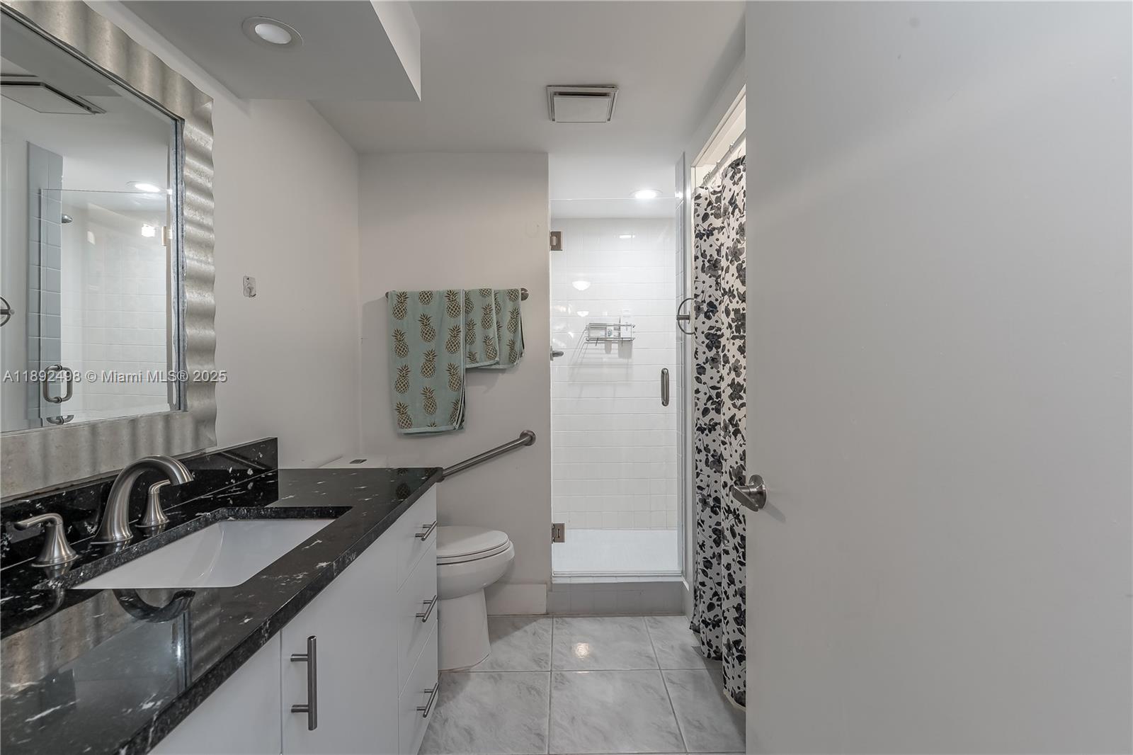 7300 Radice Court, Unit 109 Lauderhill, FL 33319 - Photo 20 of 35 a bathroom with a sink a toilet and shower