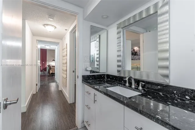 a bathroom with sink and mirror