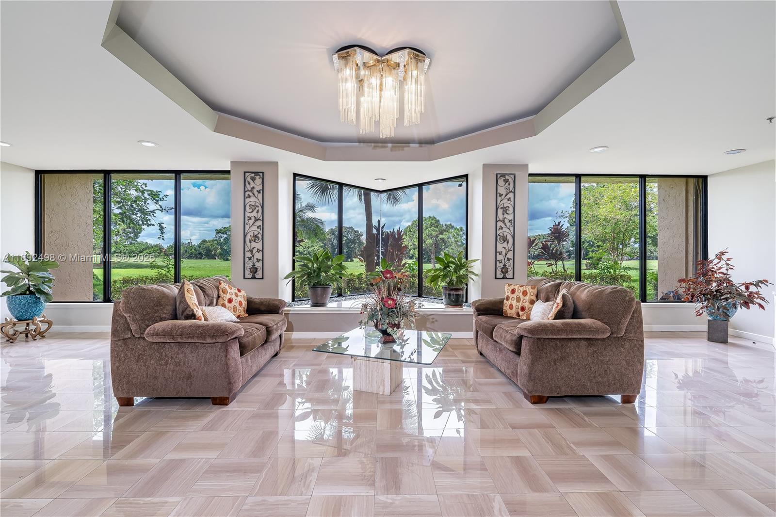 7300 Radice Court, Unit 109 Lauderhill, FL 33319 - Photo 31 of 35 a living room with furniture and a large window