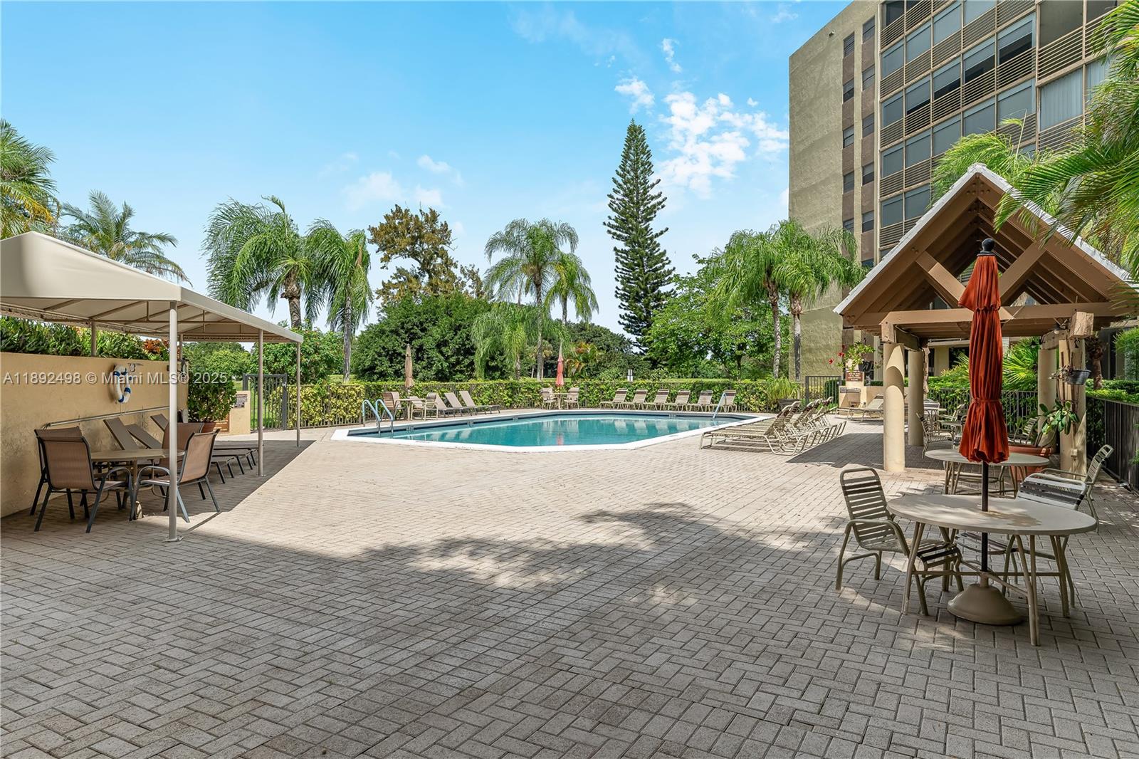 7300 Radice Court, Unit 109 Lauderhill, FL 33319 - Photo 32 of 35 a view of a house with backyard porch and sitting area