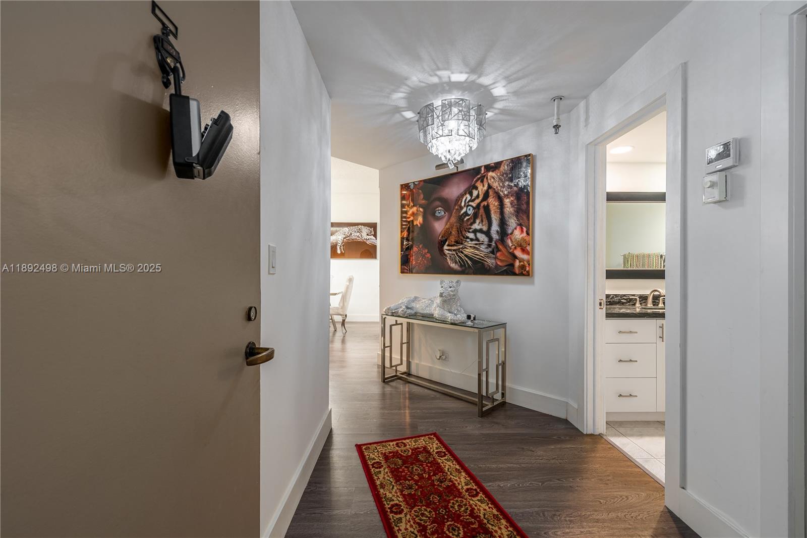 7300 Radice Court, Unit 109 Lauderhill, FL 33319 - Photo 4 of 35 a view of hall way with furniture and wooden floor