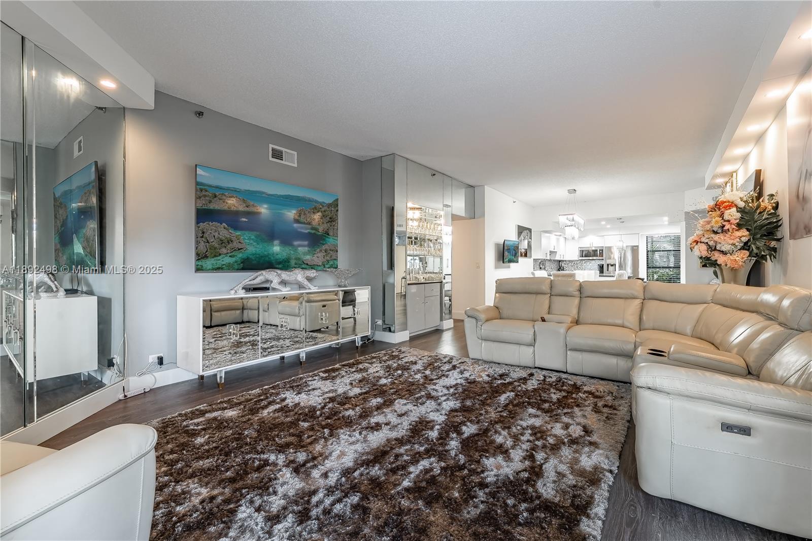 7300 Radice Court, Unit 109 Lauderhill, FL 33319 - Photo 9 of 35 a living room with furniture and a flat screen tv