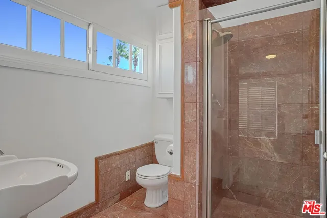 a bathroom with a toilet and a shower