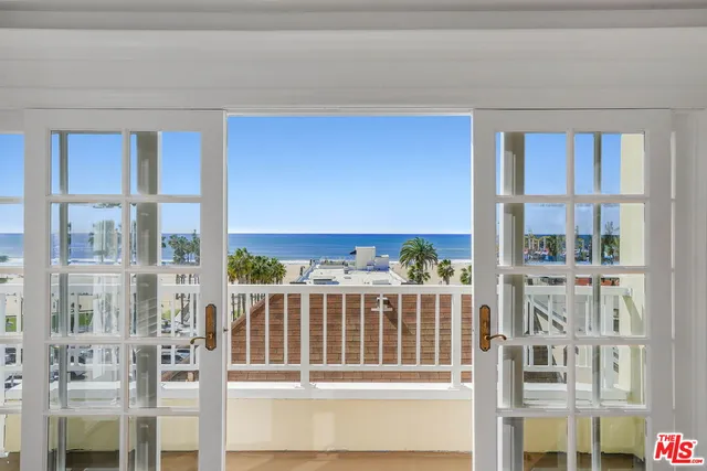 a view of a porch with a floor to ceiling window and wooden floor