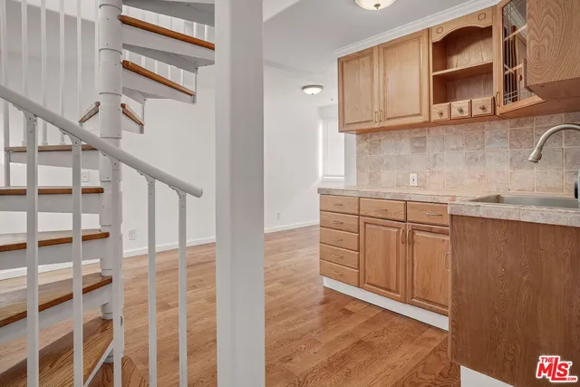 a kitchen with stainless steel appliances granite countertop a sink and a microwave oven