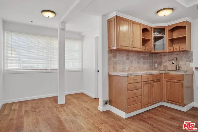 a kitchen with granite countertop a sink and cabinets