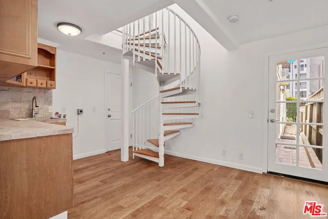 a view of entryway with wooden floor and stairs